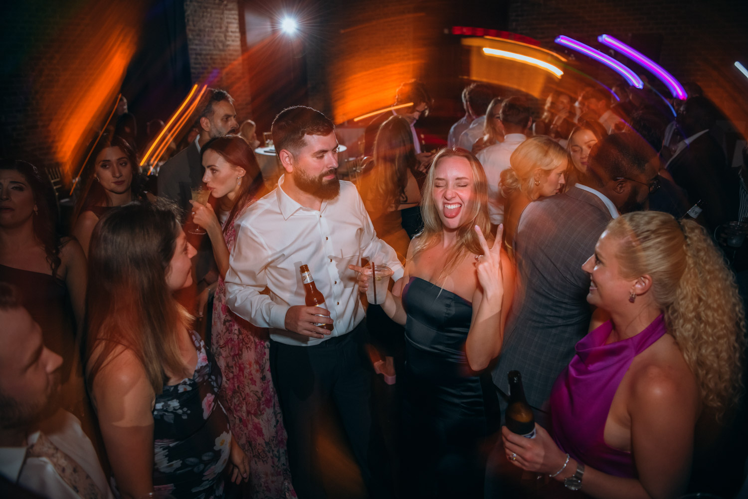 Best man and guests dancing and cheering during Savannah wedding at Charles H. Morris Center.