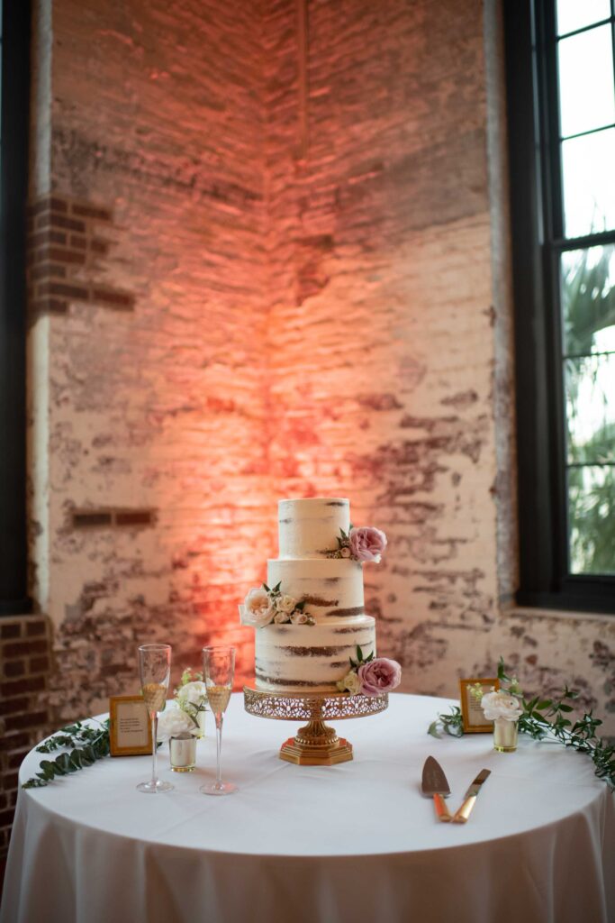 Wedding cake with fresh florals and gold leaf detail at Hilton Head reception.