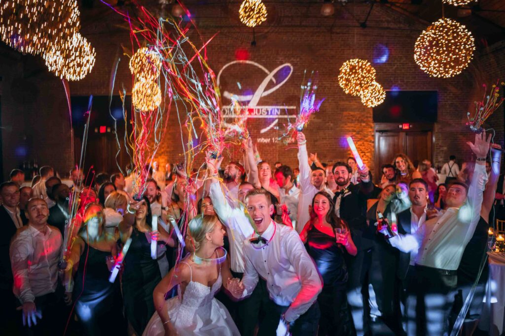 Bride and groom dancing surrounded by guests and confetti at Charles H. Morris Center in Savannah GA.