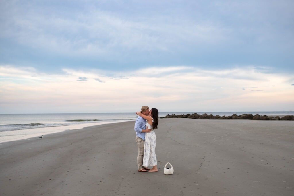 A romantic sunset engagement at Tybee Beach, just outside of Savannah, GA. Captured by Coastal Chic Studios.