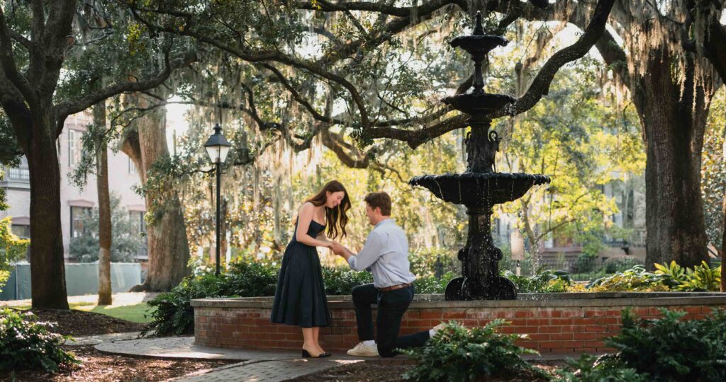Surprise proposal at the Lafayette fountain in the historic Savannah Georgia. Captured by Coastal Chic Studios, your trusted engagement photographer. 